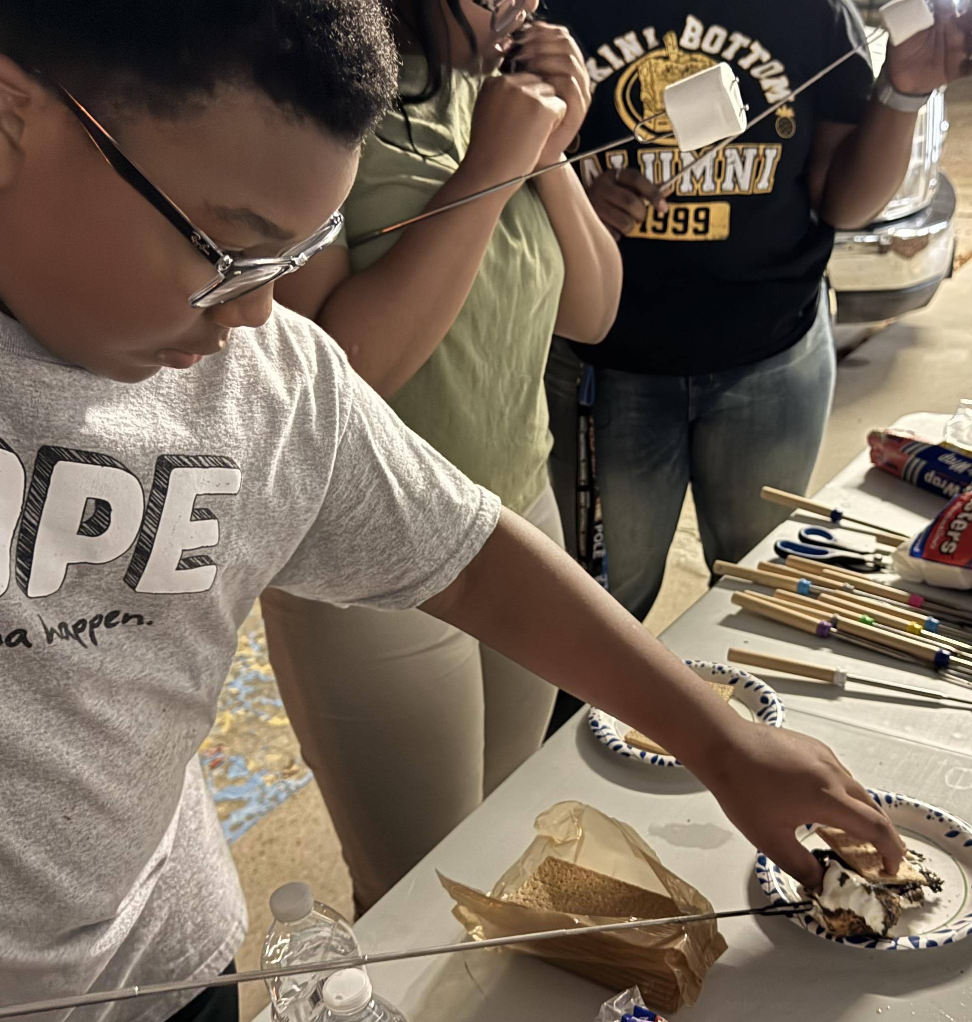 A boy making a S'more.